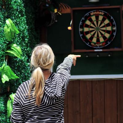 A guest playing darts.