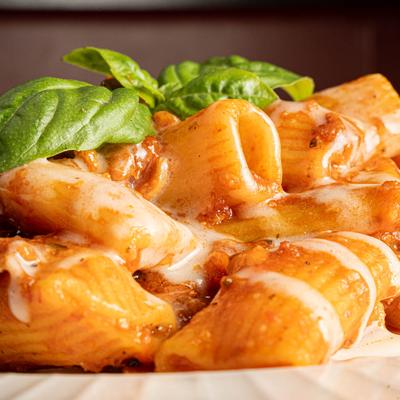 Rigatoni pasta, with bacon, pecorino cheese, basil, and spicy tomato sauce.