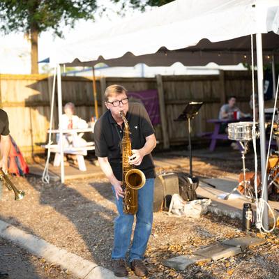 Patio, saxophonist playing live music.