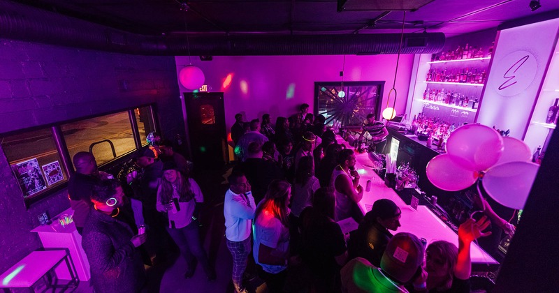 Night club interior, bar area full of guests