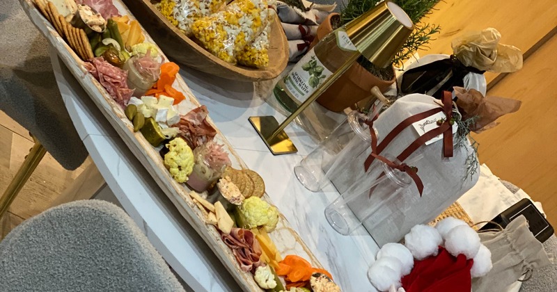 Large charcuterie board served alongside variou festive items