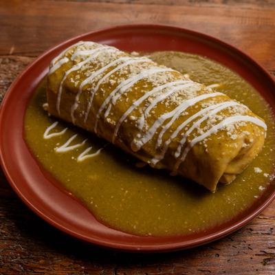 Smothered Burrito topped with salsa verde, queso fresco and drizzle of crema.