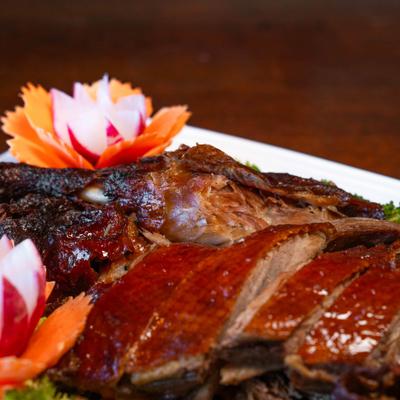 Honey-roasted duck with carrot and radish flower garnish.