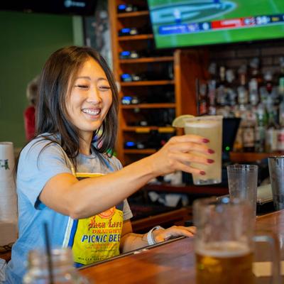 Bartender serving drinks.