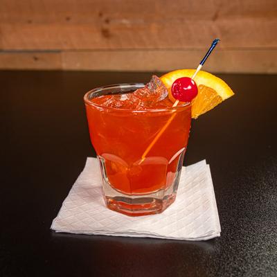 Old Fashioned garnished with a orange slice and a cherry.