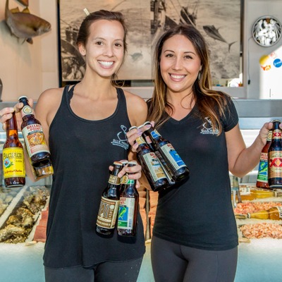 Two girls holding beer bottles