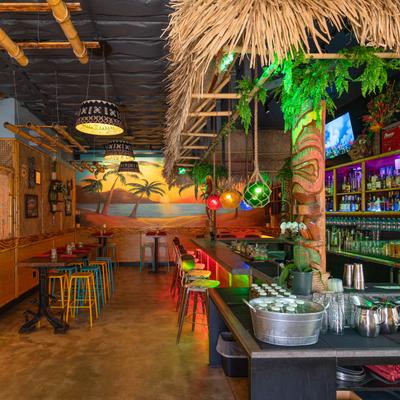 Restaurant interior with tropical setting.