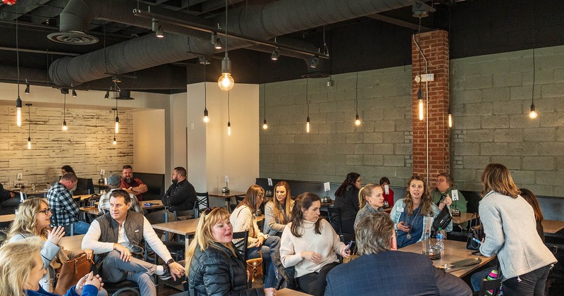 Restaurant interior, seating area with guests chatting