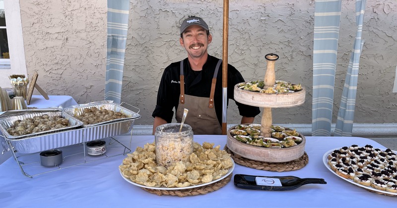 Employee at a table with catering food