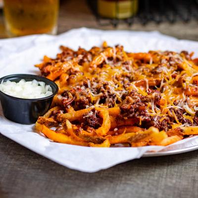 Chili cheese fries served with diced onion.