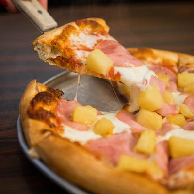 Hawaiian pizza, with ham, cheese, and pineapple.