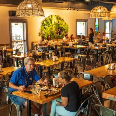 People dining inside a warmly lit restaurant.