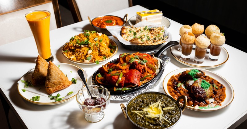 Assorted Indian dishes and drinks arranged across a dining table