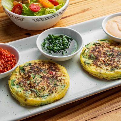 Omelet served with condiments and house salad.