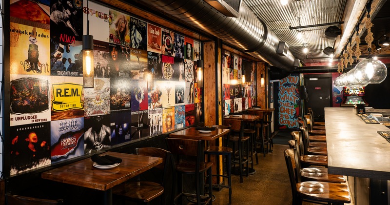 Interior, seating and bar area with vinyl collection covers on the wall