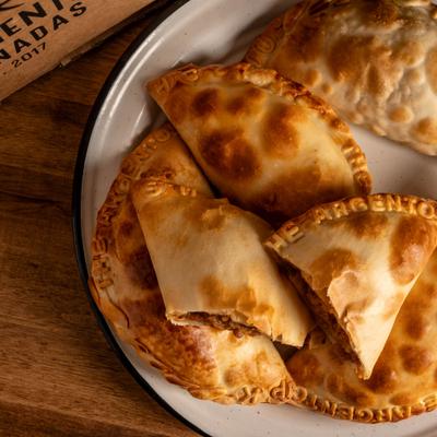 A plate of empanadas, overhead view.