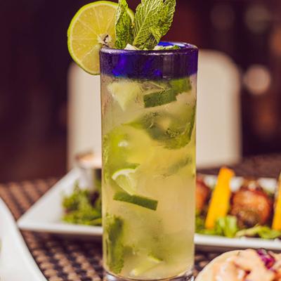 Mojito served on the table with various dishes
