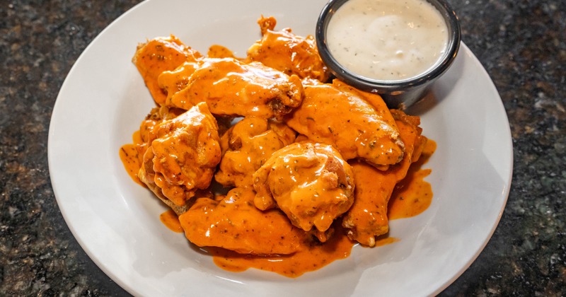 Buffalo wings served with a dip on the side