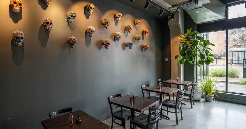Interior, tables and decorative skulls hanging on the wall