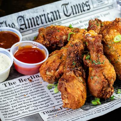 Chicken wings with sauces on the side.