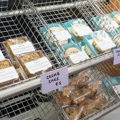 Individual packages of assorted pastries in wire baskets.