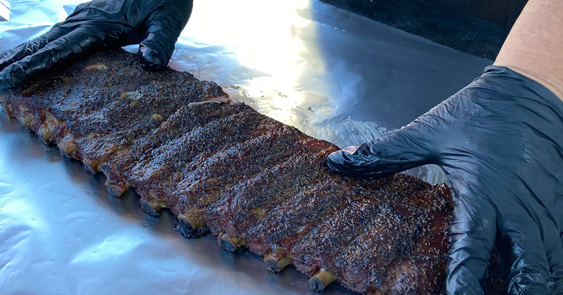 Staff member preparing meat