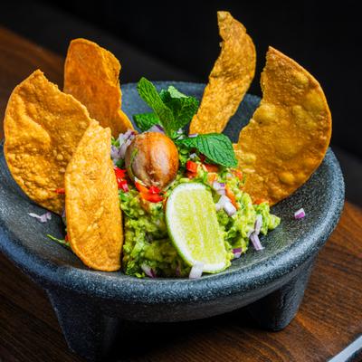 Chunky guacamole with tortilla chips.