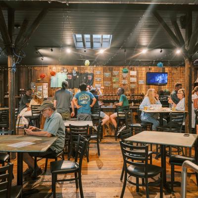 People seated inside a rustic dining room.