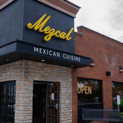 Exterior, front view to restaurant, entrance, sign above.