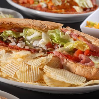 Italian Sub with cold cuts, lettuce, tomato, onions, and potato chips.
