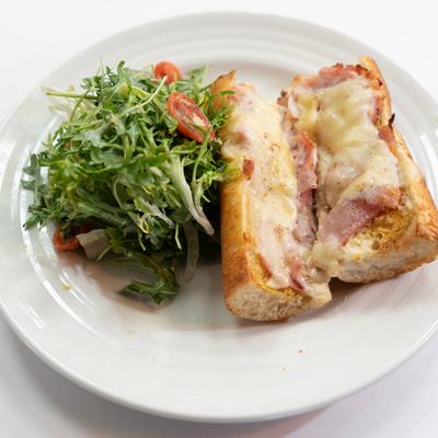 Classic croque Monsieur sandwich served with salad.