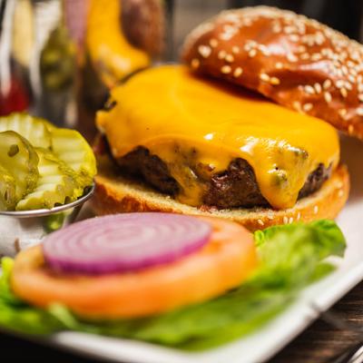 Burger served with pickle and fries.