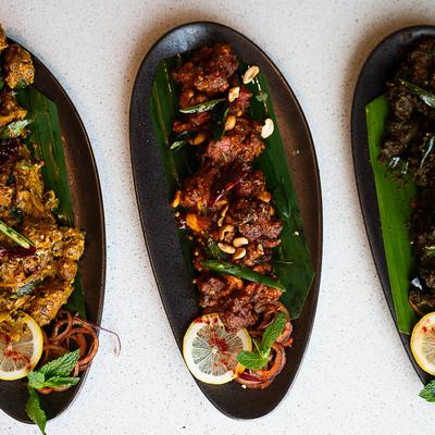 Curry leaf chicken, cashew chicken and majestic chicken plates, overhead view.