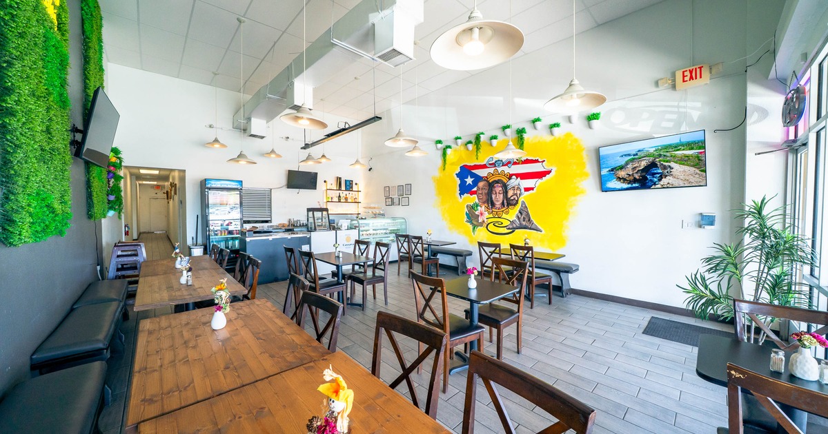 Bright cafe interior with wooden furniture, and a colorful mural