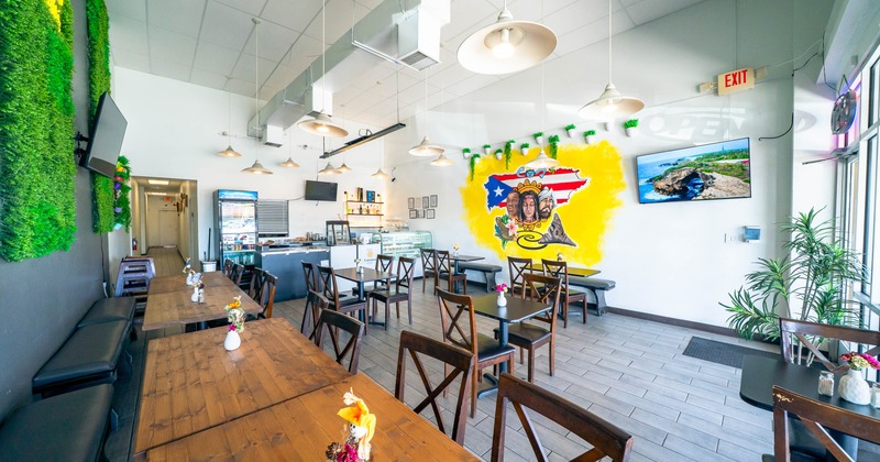 Bright cafe interior with wooden furniture, and a colorful mural