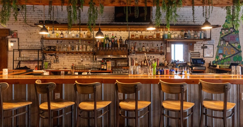 Interior, bar and bar seating, bottles of liquor, glassware, and shakers