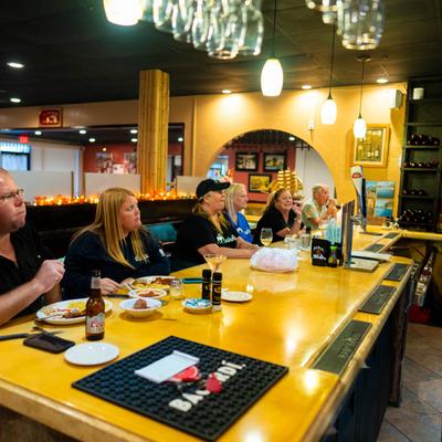 Customers dining at the bar counter.