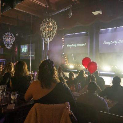 A lively crowd watching a performance on stage.