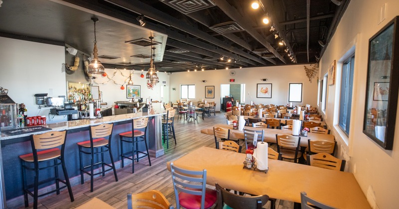 Diner area, tables and chairs, bar, side view