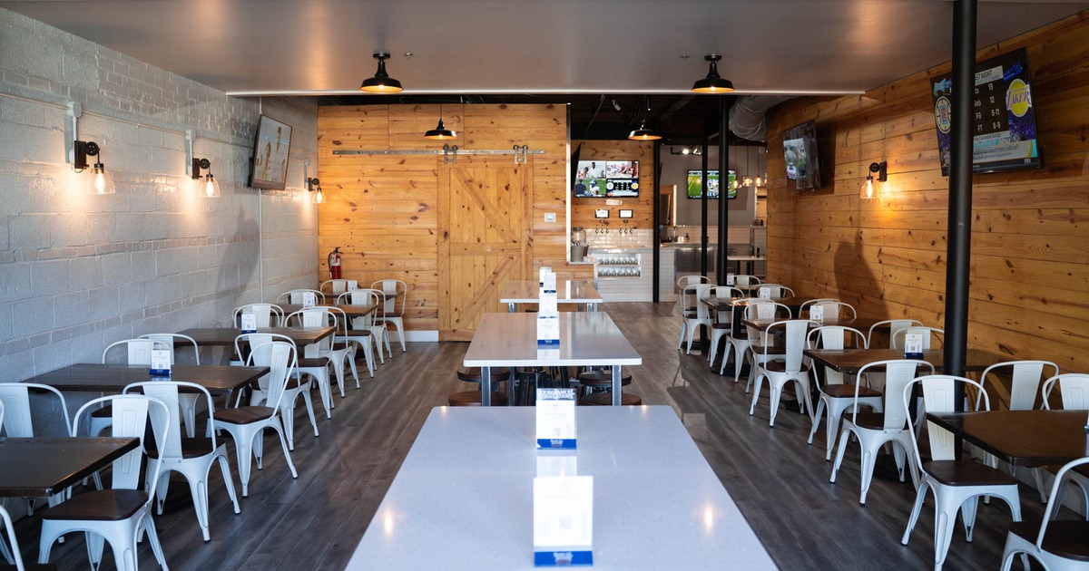 Interior, chairs and tables, TV's on the walls