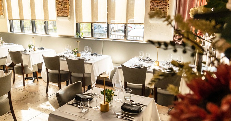 Interior, dining tables with tableware, glasses and accessories