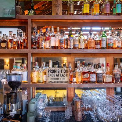 Various liquor bottles on the shelf.