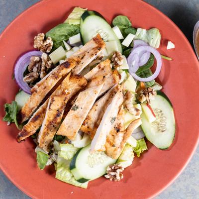 House Salad topped with grilled chicken, top view.