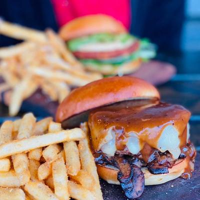 Mushroom Swiss Burger topped with bourbon gravy, served with fries.