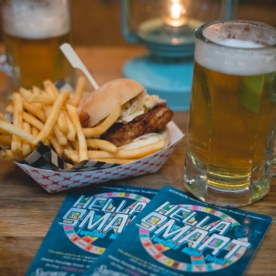 Fried chicken slider with fries and a glass of beer.