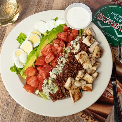 Chicken Cobb Salad, with assorted vegetables, boiled eggs, cheese and dressing