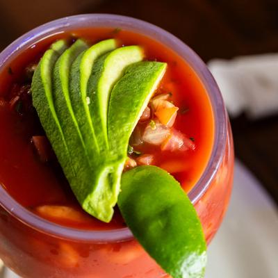 Shrimp cocktail topped with avocado slices.