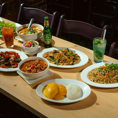 A table filled with assorted food plates and drinks.