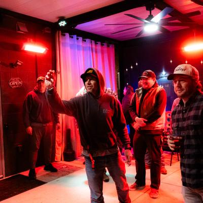 Group of people playing a game of darts.