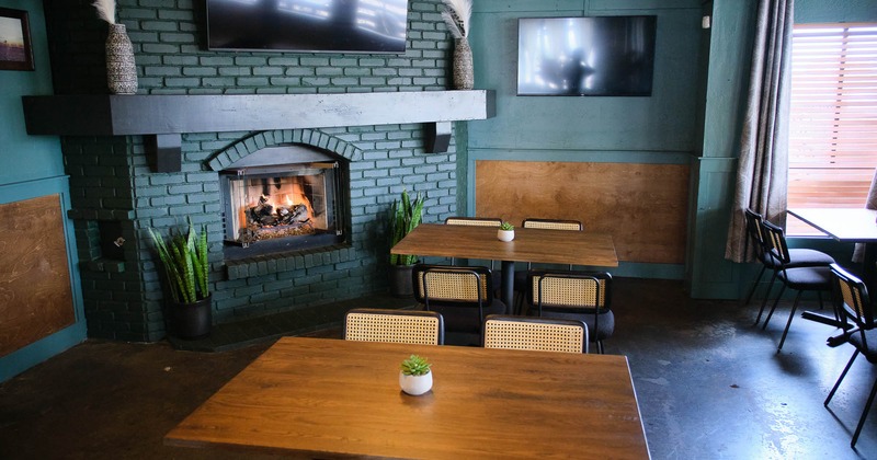 Interior, tables and chairs near fireplace